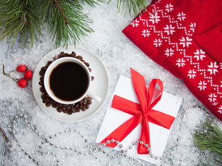 hot coffee, red warm pullover and gift with a red bow  on a snowy background