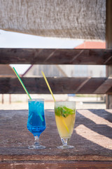 Colourful cocktails with ice on the beach in the hot summer