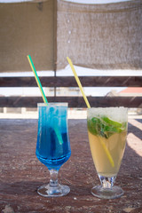 Colourful cocktails with ice on the beach in the hot summer