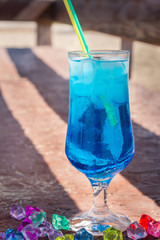 Colourful cocktails with ice on the beach in the hot summer