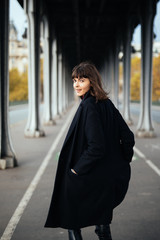 Obraz premium Portrait of a Stylish Pretty Young Woman in Autumn Fashion walking the city Looking at the Camera. Fashion woman. Beautiful fashionable woman standing on the city street.