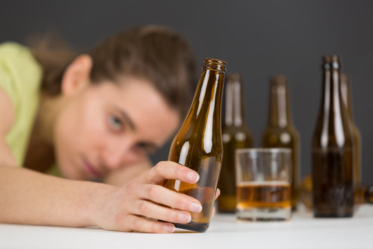 girl in depression drinking alcohol in solitude