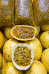 Fresh passionfruit maracuja cut open to reveal juicy seed interior at Brazilian farmers market in Rio de Janeiro Brazil