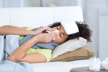 young woman sick on the sofa