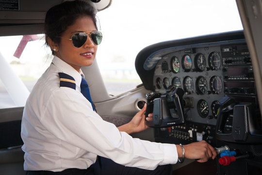 Female Pilot At The Aircraft Controls
