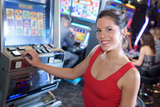 beautiful girl playing slot machines in the casino