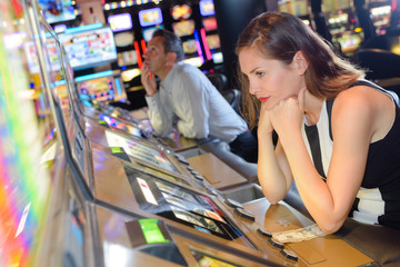 Woman losing on machine in casino