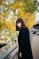 Outdoor fashion portrait of glamour sensual young stylish lady wearing trendy fall outfit , black coat on Cold season on Paris streets