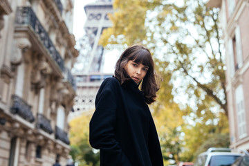 Fototapeta premium Outdoor fashion portrait of glamour sensual young stylish lady wearing trendy fall outfit , black coat on Cold season on Paris streets