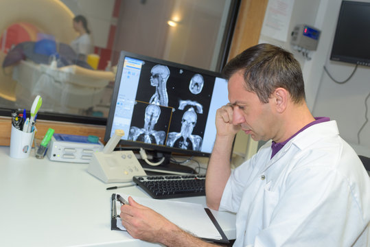 doctor examinating x-ray film from mri roentgen at hospital