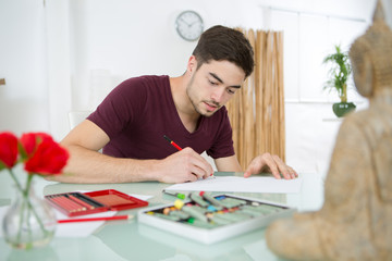 creative young man drawing at home