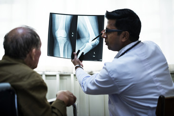 Naklejka na ściany i meble Doctor with a patient's x-ray film