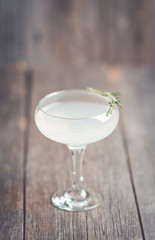 Tasty cocktail with rosemary on the rustic background. Shallow depth of field. Selective focus.