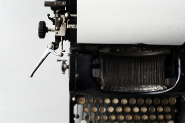 Old typewriter on white tabletop