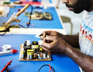 Electrical technician working on electronic board