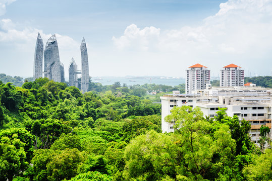 Beautiful cityscape in Singapore. Skyscrapers among green trees