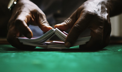 Human hands playing cards