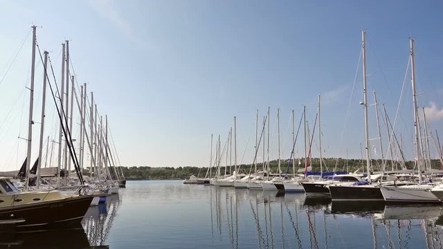 Yachts and boats parked in harbor, sunrise, morning