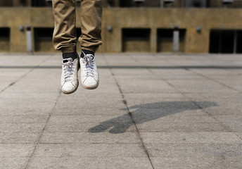 Pair of legs jumping in mid air