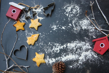 New Year or Christmas background with Xmas decorations and backed cookies on dark wooden chalkboard
