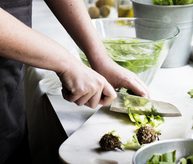 Cutting fresh vegetable with knife