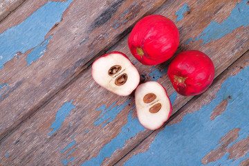 Buah Mahkota Dewa or Phaleria macrocarpa ,  Fruit of Crown Of God, God's crown   on the top of old wood 