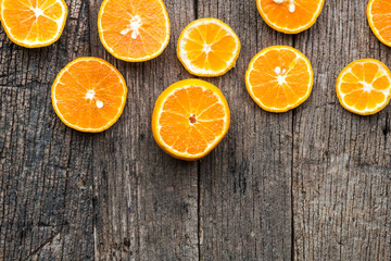 Orange fruit slice top view on wooden background