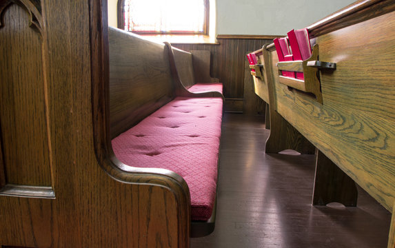 Empty Church Pew. Interior of an empty church with pew and row of bibles.