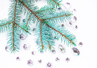 Blue spruce branch with crystals for decoration.