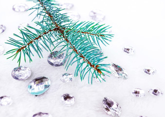 Blue spruce branch with crystals for decoration.