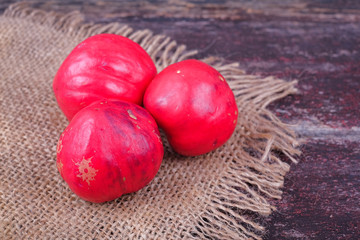 Buah Mahkota Dewa or Phaleria macrocarpa ,  Fruit of Crown Of God, God's crown   on the top of old wood 