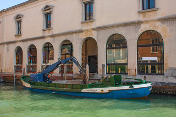Fototapeta na wymiar Venice City of Italy. View on technical ship vessel. Venetian Landscape with boat