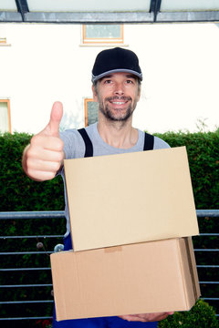 friendly postman with parcels and thumb up