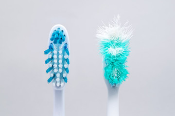 Image of used old and new toothbrushes isolated on a white background