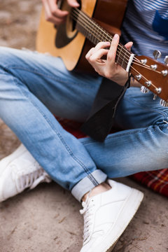 Music lifestyle man playing guitar concept. Stroller man at the nature. Artist instruments advertisement.