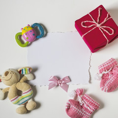 Fototapeta na wymiar Children's accessories. A gift, rattles and pinets. On a white background. Top view, flat lay