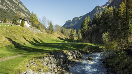 Spring river in alpine golf course