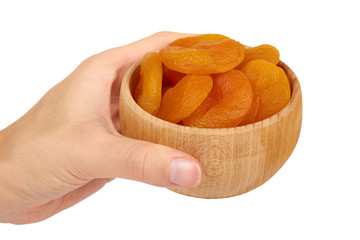 delicious and healthy dried apricots in wooden bowl in hand isolated on white background, healthy sweet snack