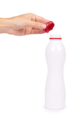 bottle of yoghurt with a red cap in hand isolated on white background, healthy lifestyle, plastic container for milk