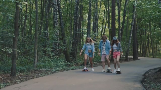 Young friends skateboarding outdoors