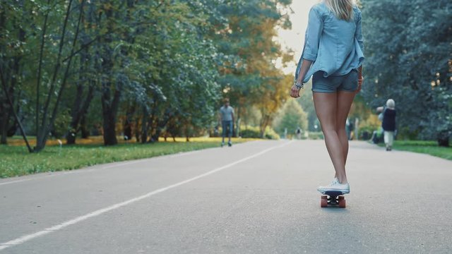 Attractive girl skating on skateboard