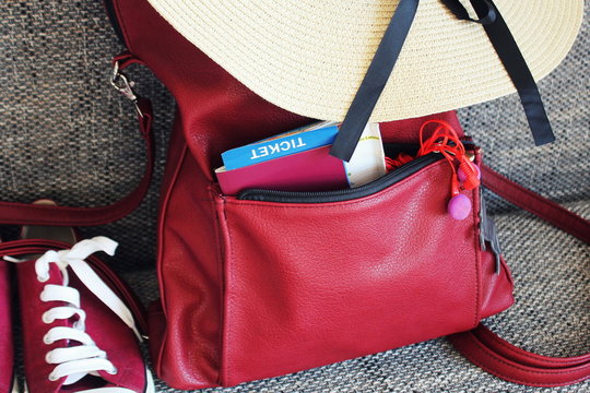 Women s summer outfit: red sneakers, backpack, hat . Traveling background and tourist stuffs