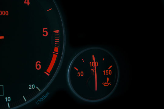 Coolant temperature gauge and tachometer on a car's dashboard. Modern Car interior details. Close up view