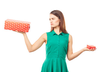 Portrait of young woman holding big gift box in one hand and small in another