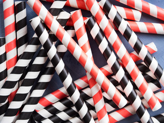Red and black striped straws background. Party cocktail concept