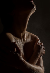 sexy nude female neck and shoulders with water drops on a black background