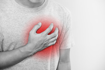 a man touching his heart, with red highlight of heart attack, heart failure and others heart disease