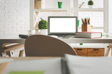 Modern workplace with white laptop screen