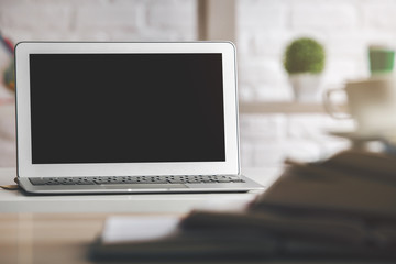 Modern desk with white laptop screen