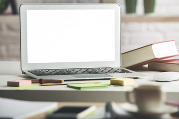 Modern table with empty white laptop display